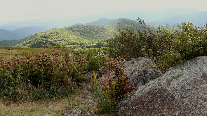 Rocky mountainside with the mountain range in view.
