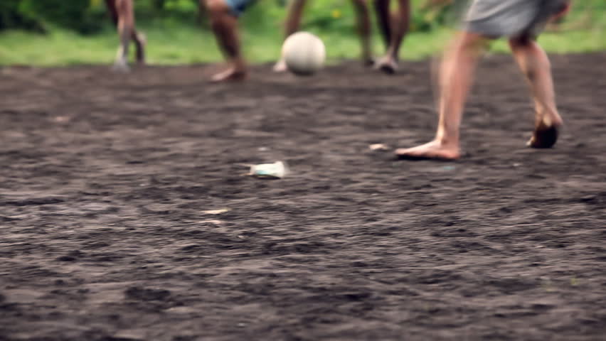 A gang of bar feet kids playing soccer on a muddy field. Serial of slow motion shots with depth of field effects. Action loaded details of running legs and goal shots. [b]HD1080 | 30fps[/b] Royalty-Free Stock Footage #1191610