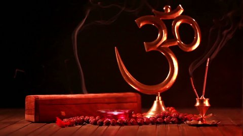 Woman blow out the candle on altar with om symbol and smoking incense and religious symbols at Diwali celebration วิดีโอสต็อก
