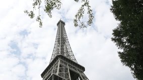 Symbol of France on Champ de Mars in Paris by the day 4K 2160p 30 fps UltraHD tilting   footage - French Eiffel tower lattice construction and cloudy sky 4K 3840X2160 UHD tilt  video