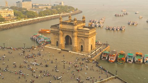 India - March 2015: Mumbai time lapse India Gate Maharashtra Asia monument Bombay illuminated dusk boat people tourist