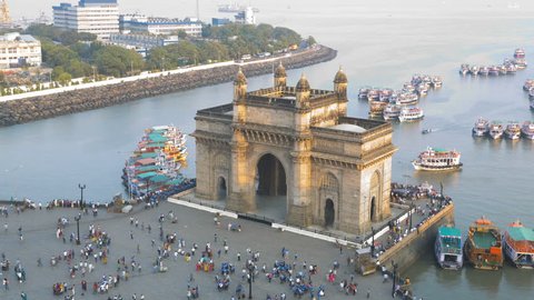 India - March 2015: Mumbai time lapse Gateway India Maharashtra Asia monument boat tower building sea city people Port