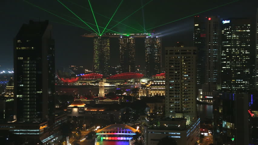 Singapore - March 2015: Clarke Quay city skyline laser illuminated night lights neon skyscraper riverside downtown waterfront marina boat travel