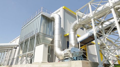 New modern industrial waste plant pipelines from the outside. Waste-to-energy plant. Produces a combustible fuel commodity, such as methane, methanol, ethanol and synthetic fuels.