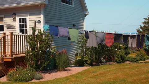 Clothes drying in the wind on a clothesline outside in the sun