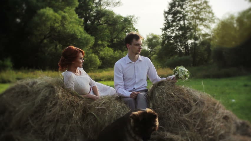 young couple lying on a haystack