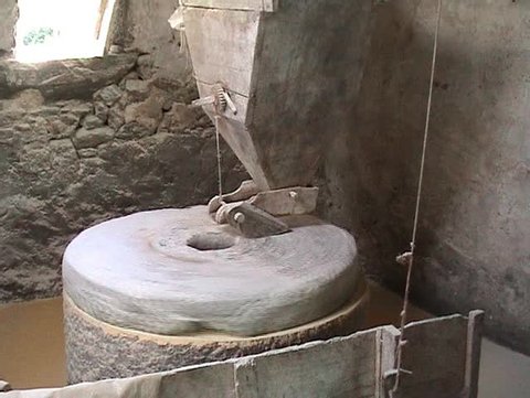 Interior of very old watermill grinding maize