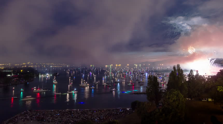 Time lapse night view of English Bay in downtown Vancouver of fireworks event and afterwards with people and boats leaving