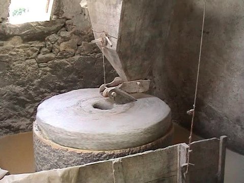 Interior of very old watermill grinding maize