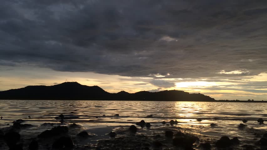 Beautiful clouds over a lake at sunset. Full HD 1080p time lapse