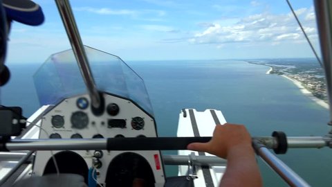 Seaplane, open cockpit flying in Florida, Gulf Coast area.