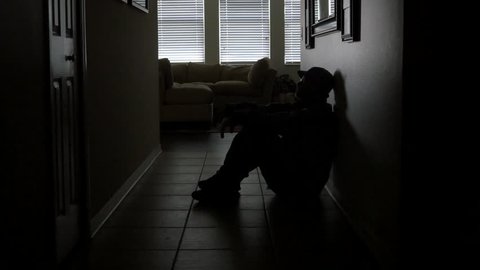 A soldier's sits in a dark hallway while dealing with PTSD, WIDE, 4K