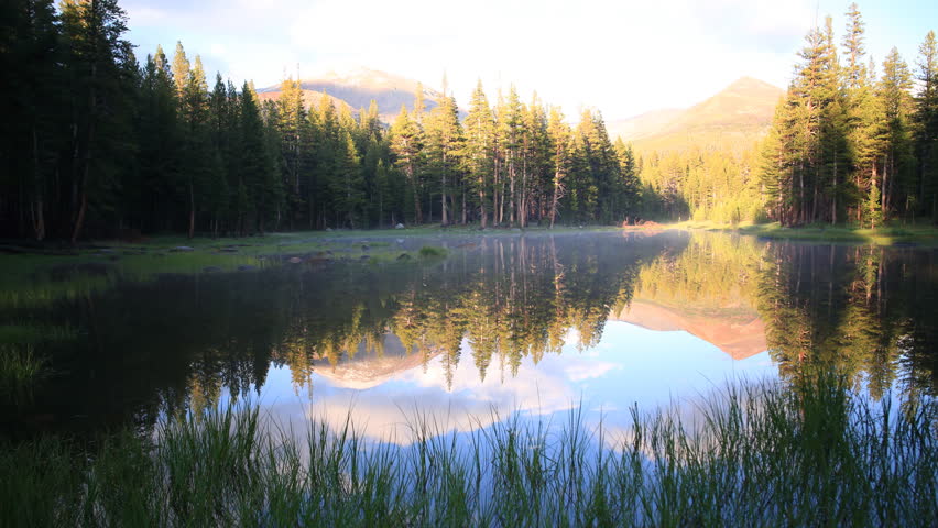 3 axis motion controlled Time-lapse footage with dolly left / tilt up / pan right / zoom in motion of alpine lake reflection at sunset in Yosemite National Park, California