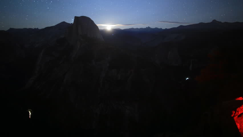 Time-lapse footage with tilt up motion of moon rising over Half Dome in Yosemite National Park, California