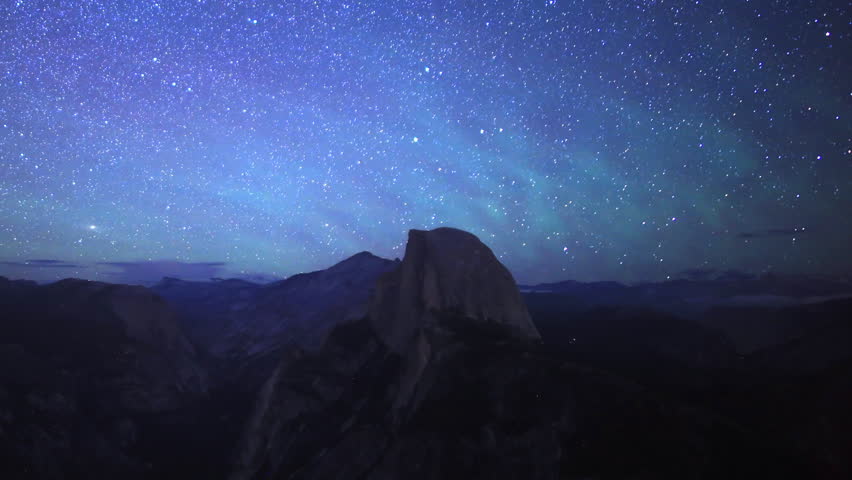 Time-lapse footage of starry sky and low latitude aurora over Half Dome in Yosemite National Park, California