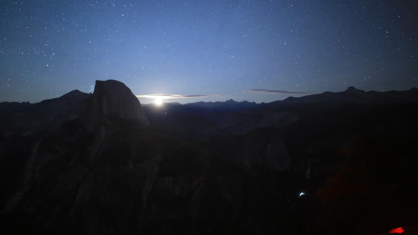 Time-lapse footage with pan left motion of moon rising over Half Dome in Yosemite National Park, California