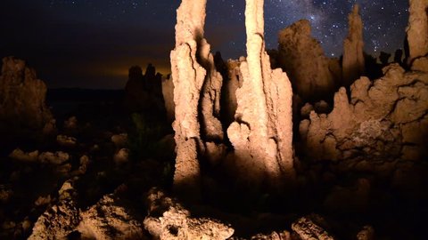 3 axis motion controlled astrophotography Time-lapse footage with dolly in, tilt up & pan right motion of milky way galaxy over illuminated tufa formations at Mono Lake, California -Long Shot-