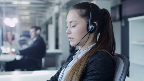 Female Customer Support Worker in Call Center.  Shot on RED Cinema Camera in 4K (UHD).