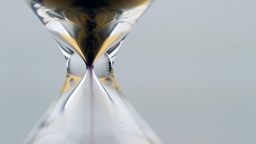 hourglass close up macro, as sand speeds away
