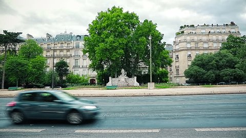 PARIS, FRANCE - JULY 9, 2015: Cars passing on famous Avenue Foch pan to the Arc de Triomphe in the city center.