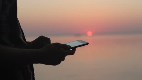 Tablet in hands of guy on the sunset nature Full HD Stock Video