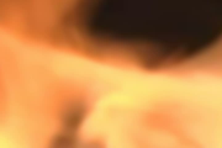 Close shot of flames of a fire flickering. looping