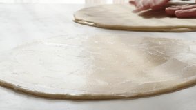 Professional puff pastry making with fat spreading over dough with knife 4K 2160p UltraHD footage - Laminated dough layer on table butter spreading 4K 3840X2160 UHD video
