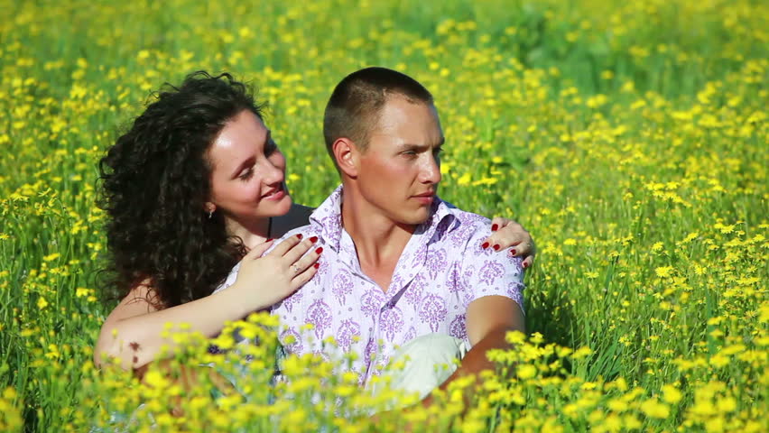 Portrait of love couple hugging in meadow 