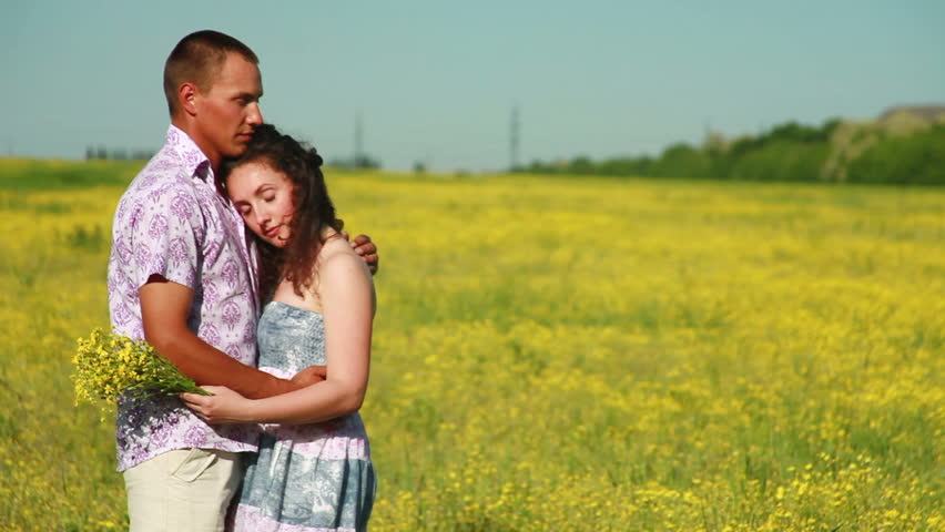 Portrait of a sweet couple in meadow. 