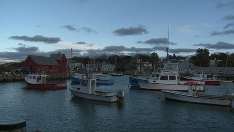 Boston, Massachusetts - September, 2012: Panning shot at sundown of Rockport Harbor from Motif Number 1, a famous red fishing shack on Bradley Wharf. 