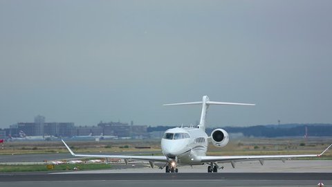 FRANKFURT AM MAIN, GERMANY - SEPTEMBER 5, 2015: Private Jet Bombardier Challenger 300 OE-HUG on executive at runway18. Unofficial spotting in Fraport on Sep. 5, 2015