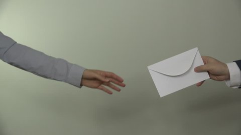 People hands exchange envelope on white background. Male man in suit give envelope gift for business partner woman. Bribery in government. Closeup shot. 4K UHD video clip.