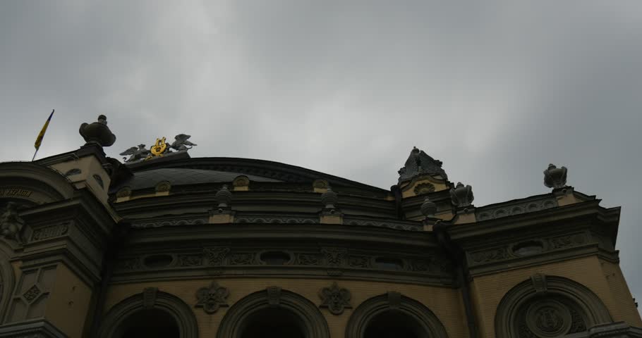 A magnificent building in the foreground of the dark cloudy sky. Theatre building, built in in Neo-Renaissance style, was constructed in 1987 - 1901, architect - Victor Schroeter, is one of the most