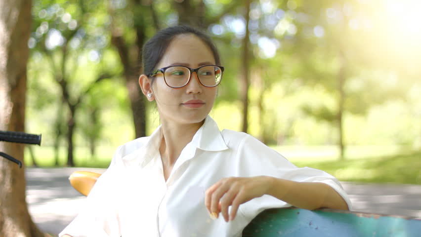 Young Woman sitting on bench in the park