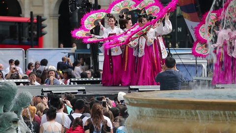  LONDON - AUGUST 9: Korean ethnic dancers perform, Buchaechum, fan dance, in Korean Festival at Trafalgar Square on August 9, 2015 in London, UK.