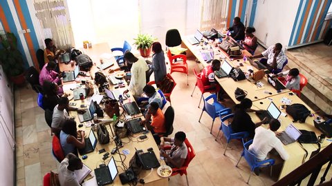 LAGOS, NIGERIA - CIRCA MAY 2014: African startup company. Overhead, employees of tech company in Africa. 1080p HD.