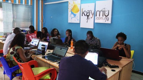LAGOS, NIGERIA - CIRCA MAY 2014: African startup company. 'Kaymu' employees work on laptop computers. Kaymu is an online marketplace for emerging countries. 1080p HD.