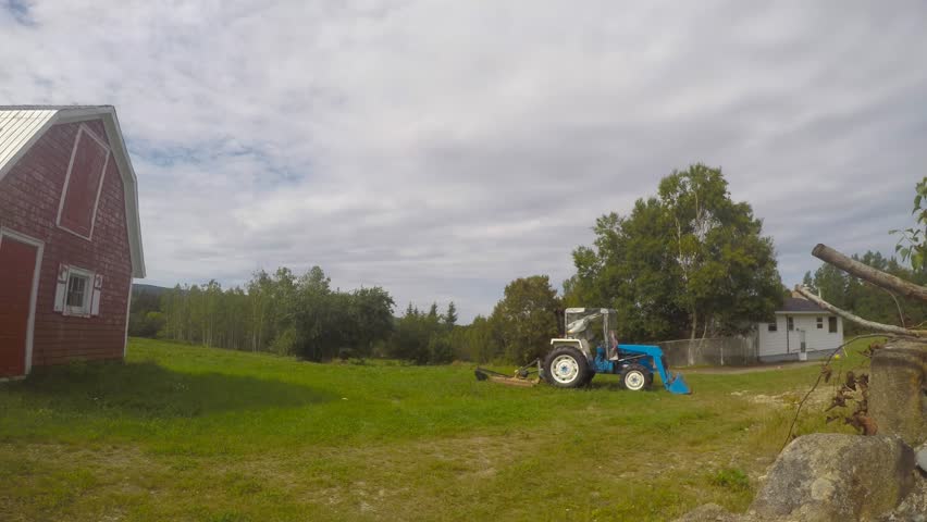 Panning time-lapse clip of field and old Canadian barn in Cape Breton, Canada