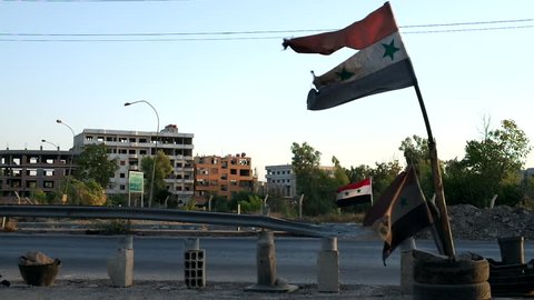 Disheveled Syrian flag at the entrance near the road to Damascus, Syria, September 2013