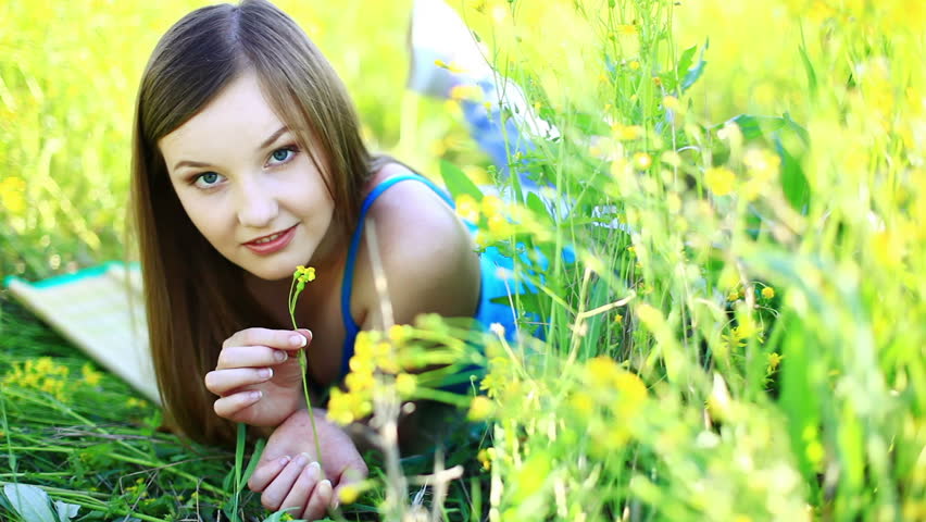 Beautiful teen in a yellow field. tripod pan. 