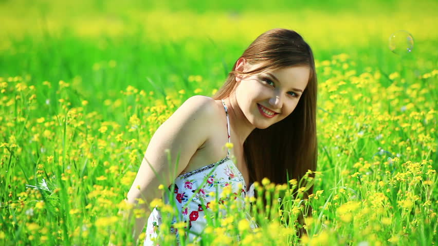 Young woman in the yellow meadow 