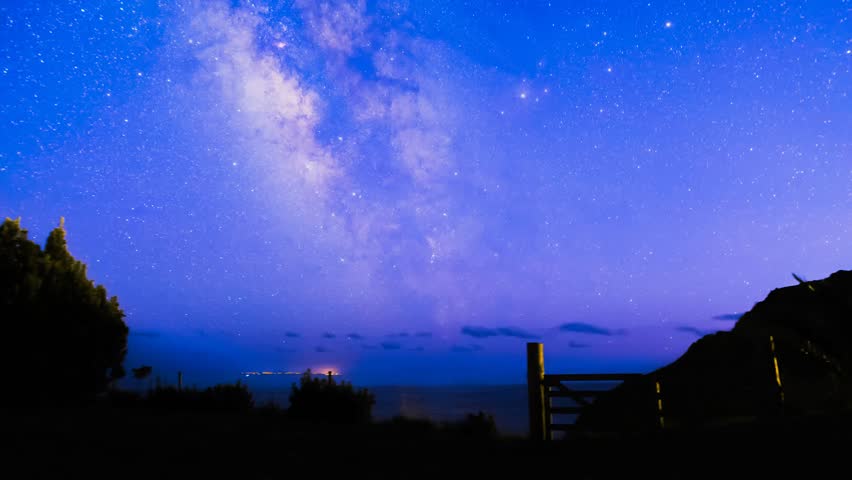 The Milky Way panning over the Island of Sao Miguel, Azores. Distant lights come from the island Santa Maria, more that 100 miles away.