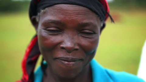 Smiling African woman wearing head scarf, focus rack, Kenya, Africa -April, 2013.  
