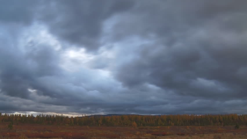 Dark Clouds over the Forest. Dark clouds quickly moving over autumn forest and mountain. Time lapse. Wildlife of the Ural 