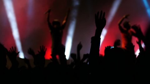 BLAGOEVGRAD, BULGARIA - SEP 26, 2015 - Free public music concert - Cheering crowd fan audience in lumiere light dancing jumping put hands up in air enjoying a music performance