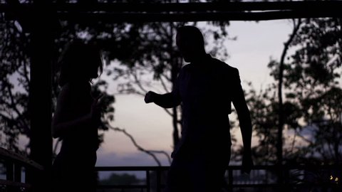 Couple having fun, dancing on terrace in evening, slow motion 240fps
