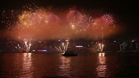 Hong Kong, Hong Kong - October 1 2015: Fireworks illuminate the sky of the Victoria harbor with the famous Hong Kong skyline as a background for the 66th China national day. 