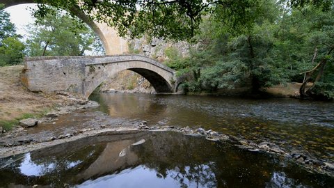 Old stone bridge over river La Cure in the Pierre-Perthuis, Burgundy, France, Europe