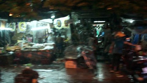 Driving a taxi through Vietnam Hue downtown rainy night active working and moving people on the side of street and busy with traffic and sound horn busy city view from side window high resolution
