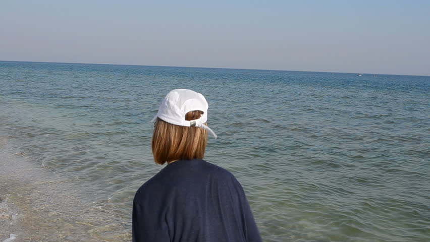 The girl runs on the seashore
